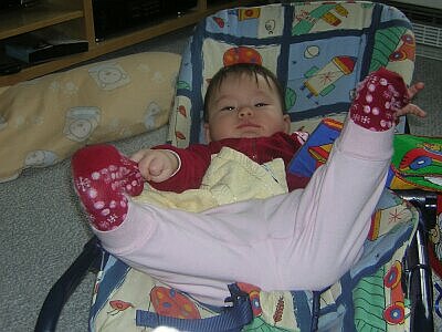 Katja liegt strampelnd in der Babywippe
